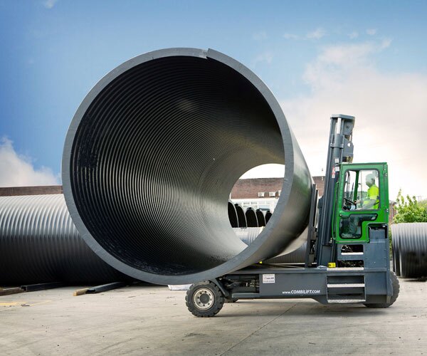 Combilift multidirectional forklifts for sale handling a large cylindrical load in an industrial yard